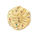Macro view of gold Scorpio pendant with colorful rhinestones and embossed details - Scorpio