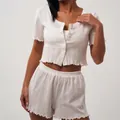 Women's white pointelle knit pajamas set with button-up short sleeve top and frill hem shorts - S / White
