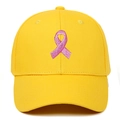 Detail of pink ribbon embroidery on bright yellow baseball cap with structured crown - Adjustable / Yellow