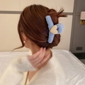 Detail of blue plush hair claw clip with cream heart accent on model's hair - Blue Plush Heart