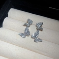 Detailed close-up of sparkling silver butterfly earrings with full zircon stones - Full Diamond Double Butterfly Tassel Stud Earrings