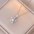 Detailed shot of spinning flower star pendant with clear zircon on silver steel chain - X1460 Steel Pentagram Rotating