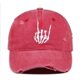 Detailed close-up of white skull gesture embroidery on red washed distressed baseball cap - Watermelon red