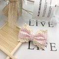 Pink checkered and beige lace fabric bow clip on a bamboo coaster in a bright setting - Pink Plaid Bow (No Clip)
