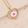 Close-up of golden heart pendant with rainbow gemstones and evil eye enamel design - Pink (2#)
