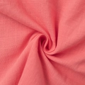 Close-up of coral pink cotton-linen fabric texture showing soft weave and draping - Coral Pink (In Stock)