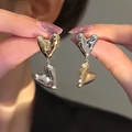 Close-up of heart-shaped two-tone metal earrings in polished gold and silver finish - 28# Silver Needle Heart Tassel Earrings