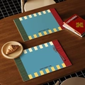 Blue geometric leather placemat with yellow stripe and Happy Every Time slogan - Vibrant Mango