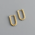 Detailed view of U-shaped gold earrings with intricate twisted texture and metallic finish - Twisted U-shaped Hoop Earrings (S-E1562) / Gold