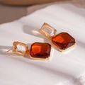 Macro shot of geometric square earrings with champagne and amber crystals in gold frame - Orange Square Crystal Drop Earrings / Orange