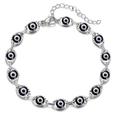 Macro view of silver evil eye bracelet featuring detailed white and black enamel beads - Silver Base Black