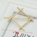 Detail of a 6.7cm golden geometric diamond-shaped metal hair clip on a white frame - Geometric Square Gold