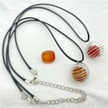 Macro detail of natural carnelian stones in silver spiral wire cages on black wax cord - Natural Red Agate / Silver Spiral Cage Style / Red Agate