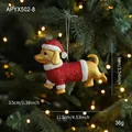 Golden dachshund Christmas ornament with red glitter hat and coat on festive tree branch - Christmas Dachshund Dog