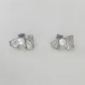Silver bow stud earrings with white pearls and vertical striped texture detail - Silver Brushed Bow Earrings (D2875)