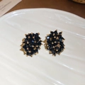 Macro shot of irregular black crystal stud earrings with gold accents on white ceramic - Cluster Irregular Style (HE29313) / Black Gold (Silver Pin-Gold-Black)