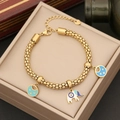Bracciale dorato con ciondoli elefante e luna stella su fodera di portagioie beige chiaro - Stile 1 Elefante Luna Stella