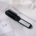 Spazzola per capelli pieghevole nera portatile con specchio integrato e massaggianti - Nero