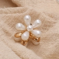 Elegant gold metal floral hair clip featuring five white pearls on a rustic background - Single Pearl Flower