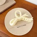 Matte cream-colored bow hair claw clip for thick hair, size 11.5x4cm on ceramic plate - 11.5cm x 4cm / White