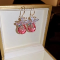 Close-up of pink pear-cut crystal earrings with blue and purple butterfly detailing in a box - Pink Butterfly Water Drop Ear Hook