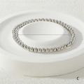 Detail of 4mm white gold stretch bracelet with 51 solid metal beads on a stone tray - 4mm / White Gold