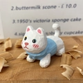 Hand-painted wooden cat carving figurine showing detailed hand-cut texture and blue outfit - White Cat Style (Xiao Bai)