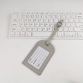 Light gray PU leather luggage tag with buckled strap and info card on white desk - Stitched Frame No-Flip Style / Gray