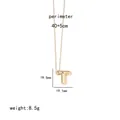 Detailed view of golden letter T pendant necklace with rounded texture on white background - Letter T
