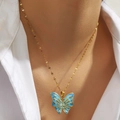 Titanium steel gold butterfly necklace with blue enamel pendant worn on a model - Blue Butterfly (DJN029GL-SB)