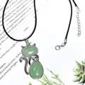 Silver cat pendant featuring green crystal stones on a black cord necklace - Green Aventurine