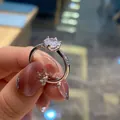 Detailed view of a six-prong silver engagement ring with a round brilliant-cut center stone - TJZ190-Classic Six-Prong Pave