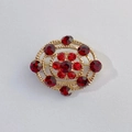 Vintage gold brooch featuring a central red floral rhinestone and double oval frame - Vintage Red Square Stone