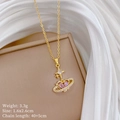 Detail of gold heart planet necklace with pink crystals on elegant silk background - Heart Planet Star Moon Style (E339)