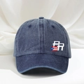 Close-up of washed blue cotton baseball cap featuring PR letters and flag embroidery - One Size / Navy Blue
