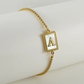 Close-up of gold adjustable bracelet featuring a white shell inlay pendant with letter A - Letter A / Gold/White Shell