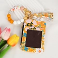 Detail of yellow floral card holder with silicone beaded bracelet and tassel charm - Bright Yellow Floral