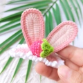 Handmade crochet hair clip featuring pink rabbit ears and a red strawberry motif - Pink Strawberry Rabbit Ears