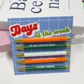 5-piece novelty pens set with sarcastic weekday quotes in orange, green and white colors - Days of the Week (Sarcastic)