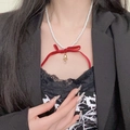 Detail of pearl necklace with red velvet bow and golden bell on black lace background - Velvet Bow Bell Artificial Pearl Necklace (DX0513) / Red