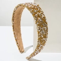 Close-up of luxury gold headband featuring faux pearls and crystals on a white pedestal - Gold