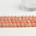 Polierte Sonnenstein-Rundperlen in Pfirsichrosa für DIY-Schmuckherstellung und Basteln - 6MM/Strang (ca. 60 Perlen) / Sonnenstein