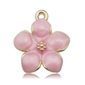 Detailed macro shot of a pink enamel cherry blossom pendant with golden metal edges - Pink