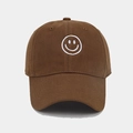 Close-up of a brown cotton baseball cap featuring white embroidered smiley face detail - Coffee
