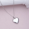 Polished silver heart locket necklace with delicate chain on a stone texture background - Steel Polished Heart (29*29mm)
