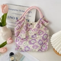 Detail of floral canvas tote bag showing pink woven handles and metal snap closure - Purple Floral