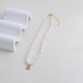 Baroque rice pearl necklace with a golden round Fu character pendant and lobster clasp - Fu Plaque Pearl Necklace