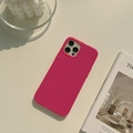 Detailed view of magenta liquid silicone phone case on a minimalist stylish desk - Jelly Rose Red / 16promax