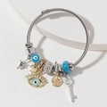 Bracciale intrecciato argento con occhio blu, corona dorata e ciondoli a chiave - Blu Lago