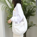 Minimalist white nylon dumpling bag with adjustable strap and silver zipper detail - White